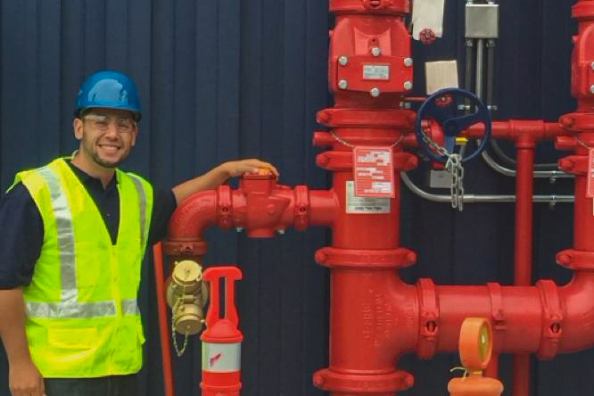 Technician inspecting a fire sprinkler system in Temecula, CA